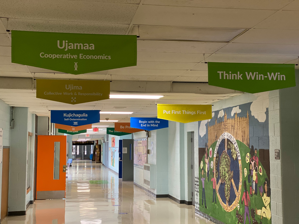 Hallways adorned with character banners and murals at a school.